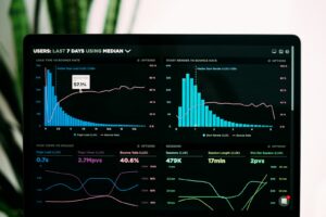 Analyst desk with charts, spreadsheets and a laptop showing comparative review data, representing the aggregated Hypnos mattress scorecard