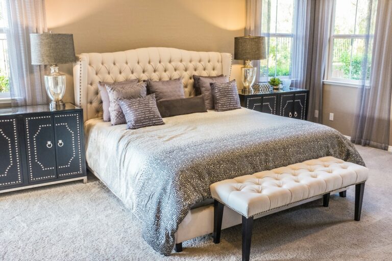 Neatly made bed with white cotton bedding in a bright minimal guest room, illustrating the sort of spare bedroom the Hypnos Cotton Comfort is built for