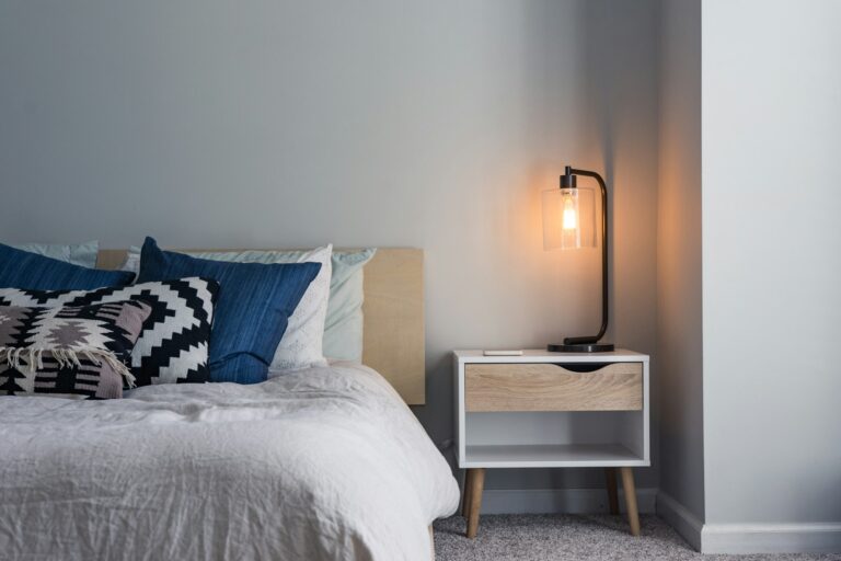 Neatly made bed with natural cotton and linen bedding in a bright bedroom, illustrating the natural-fibre feel of the Hypnos Natural Luxury mattress